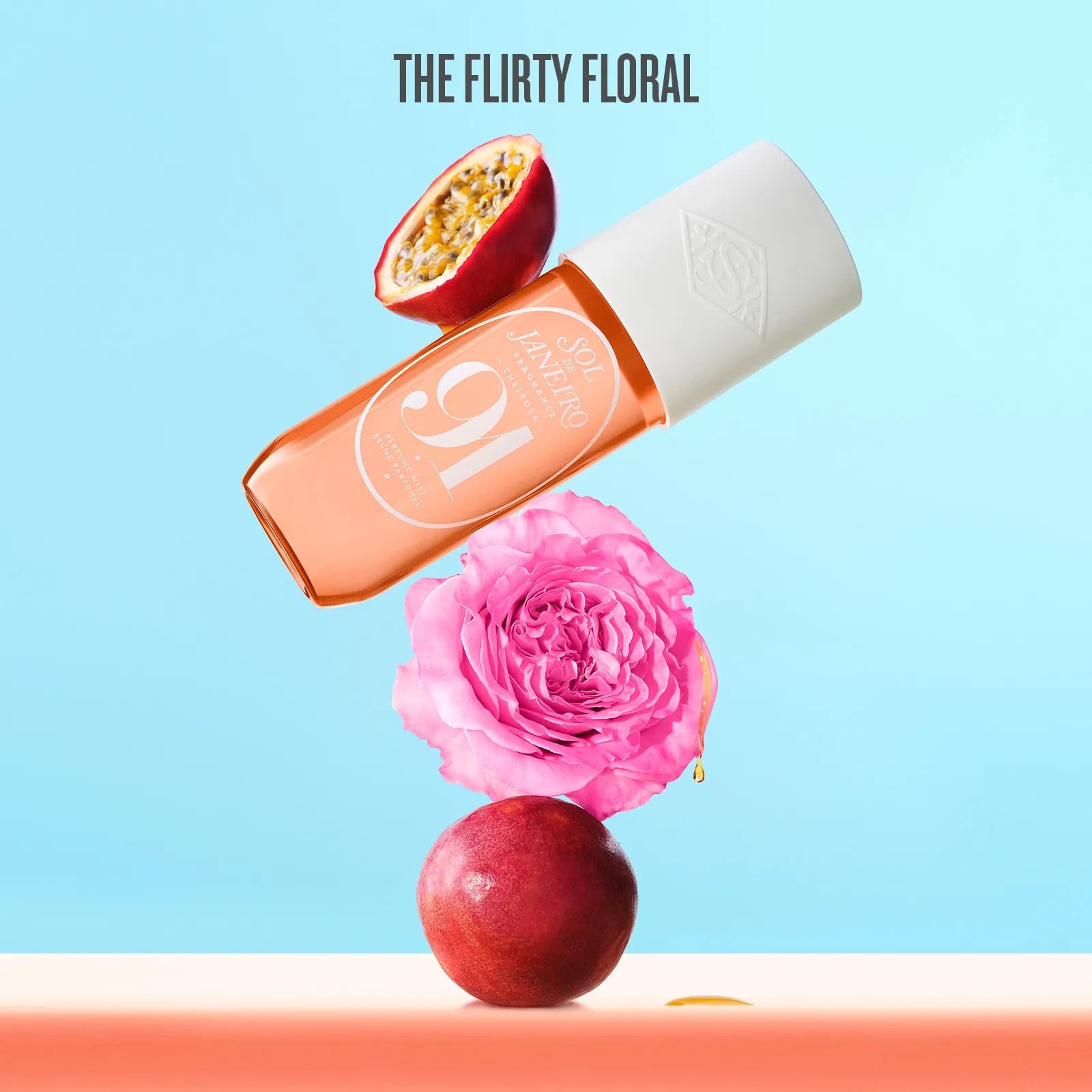 Lip balm with a pink flower and passion fruit on a light blue background, featuring 'The Flirty Floral' branding.