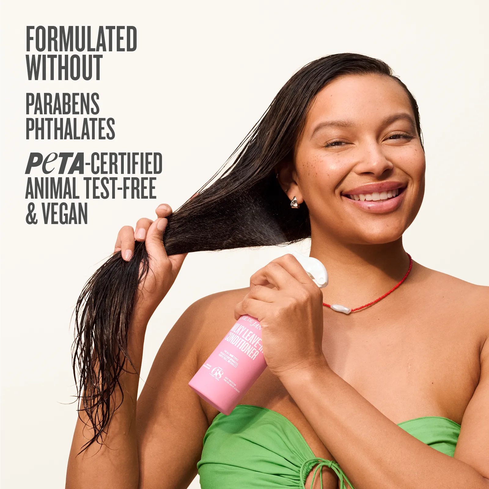 Woman holding a bottle of hair product with text about product ingredients and certifications on a white background