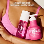 Two bottles of 'Sói de Janeiro' body lotion held by a person wearing a pink bra.