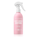Pink bottle of Milky Leave-In Conditioner with white spray nozzle on a white background