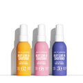 Three bottles of Milky Leave In Conditioner by Sol de Janeiro in yellow, pink, and purple on a white background.