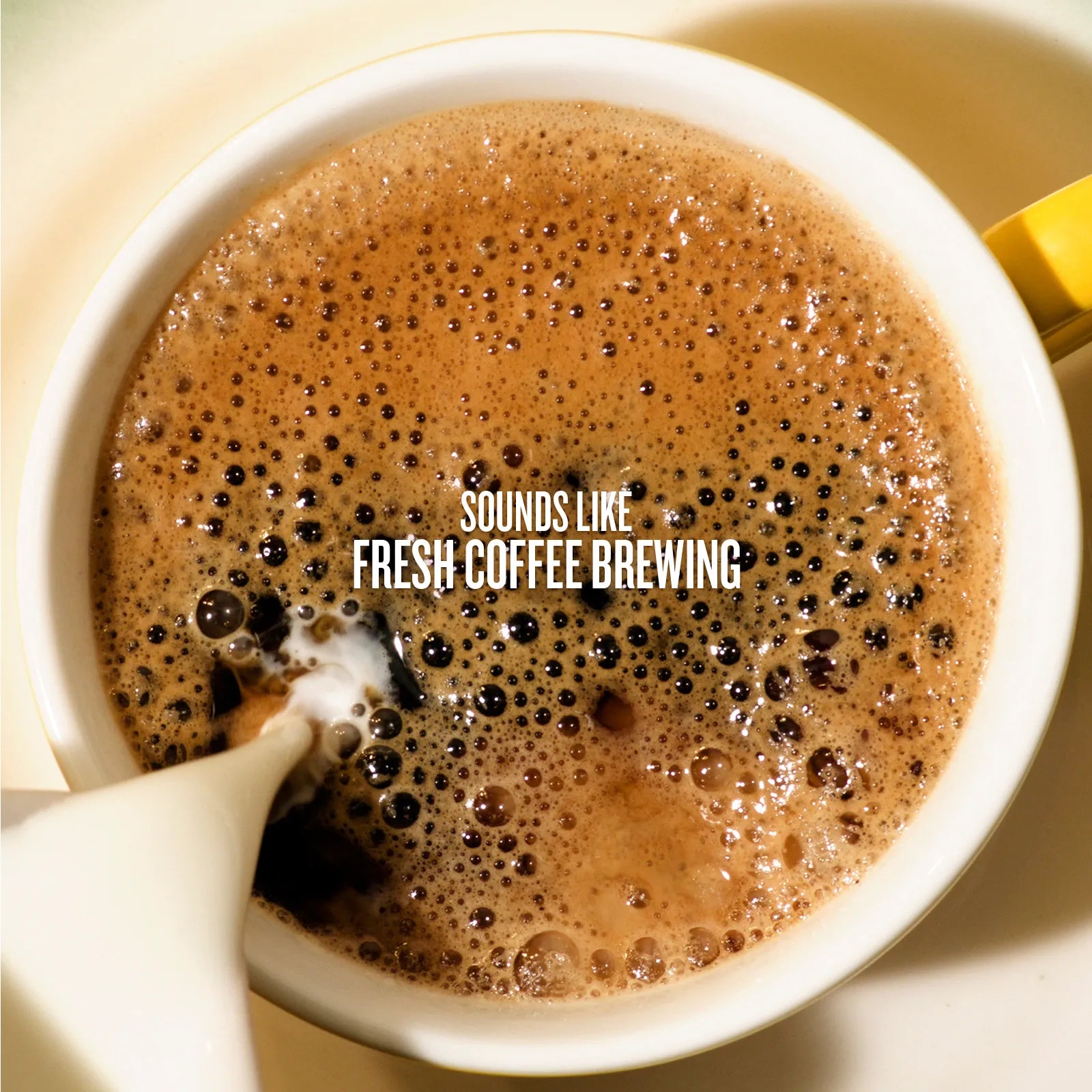 White cup with coffee and cream being poured, text 'SOUNDS LIKE FRESH COFFEE BREWING' on top.
