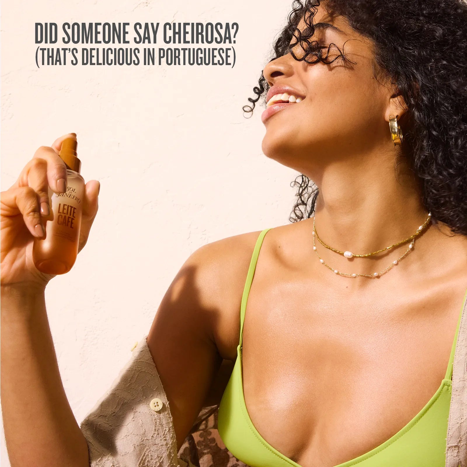 Woman holding a bottle of L'Occitane product with text about the brand name in Portuguese.