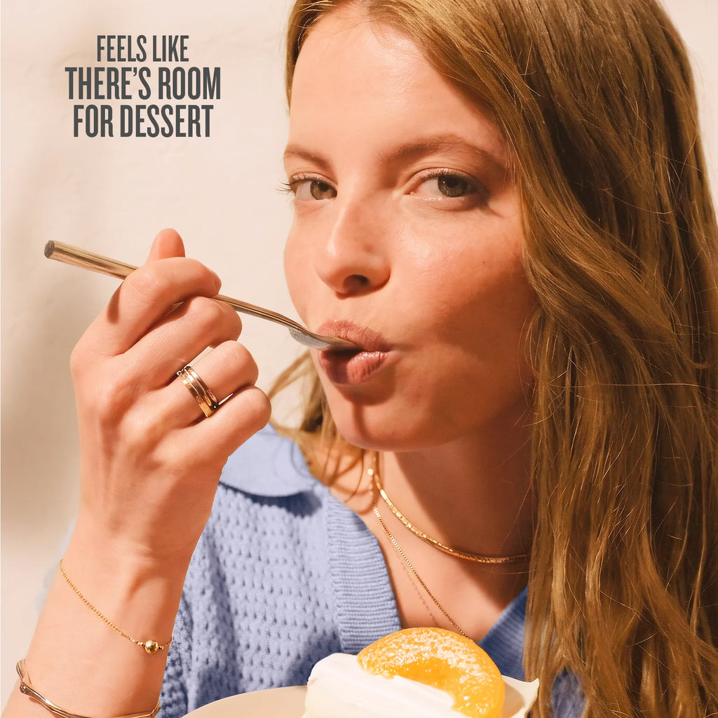Woman eating dessert with a spoon, text 'Feels like there's room for dessert' above her.